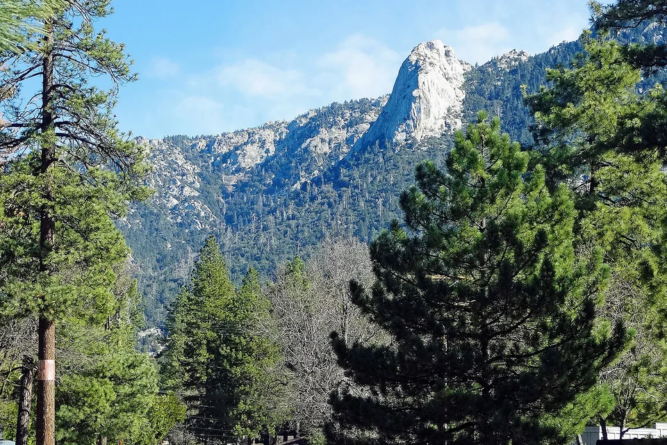Tahquitz Rock rising above pine forest near Idyllwild